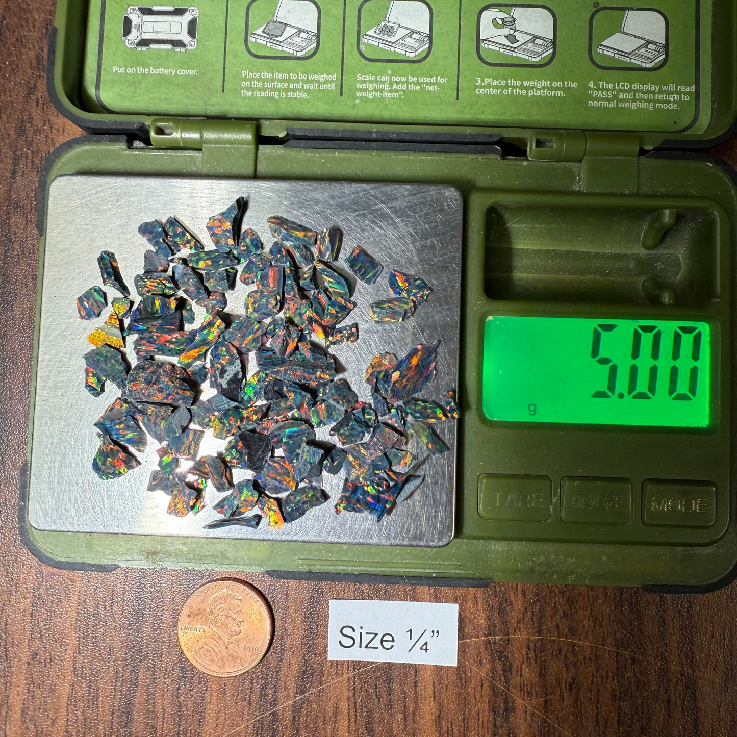 Green scale with 1/4" opal on a wooden surface.