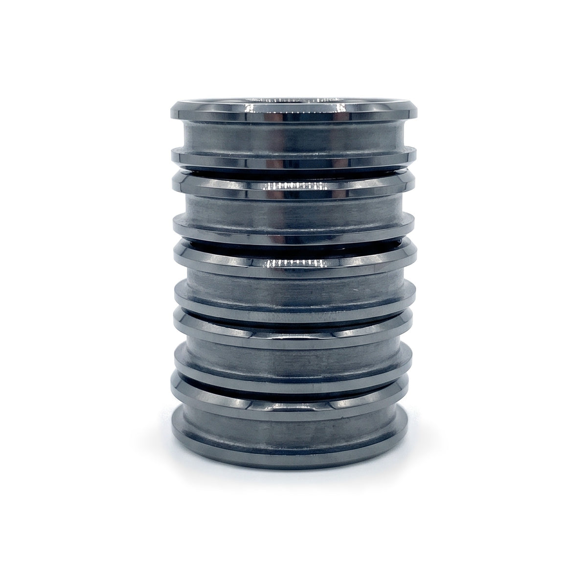 Stack of five black ceramic ring blanks with inlay channels