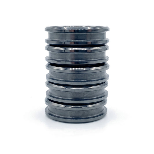Stack of five black ceramic ring blanks with inlay channels