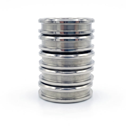 Stack of five titanium ring blanks with inlay channels