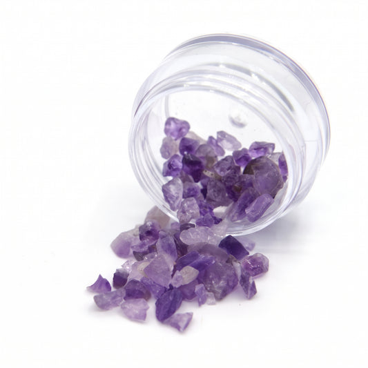 Amethyst fragments spilling from a tipped 2 g jar