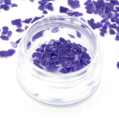 Close-up of purple Colorstone fragments in a small jar