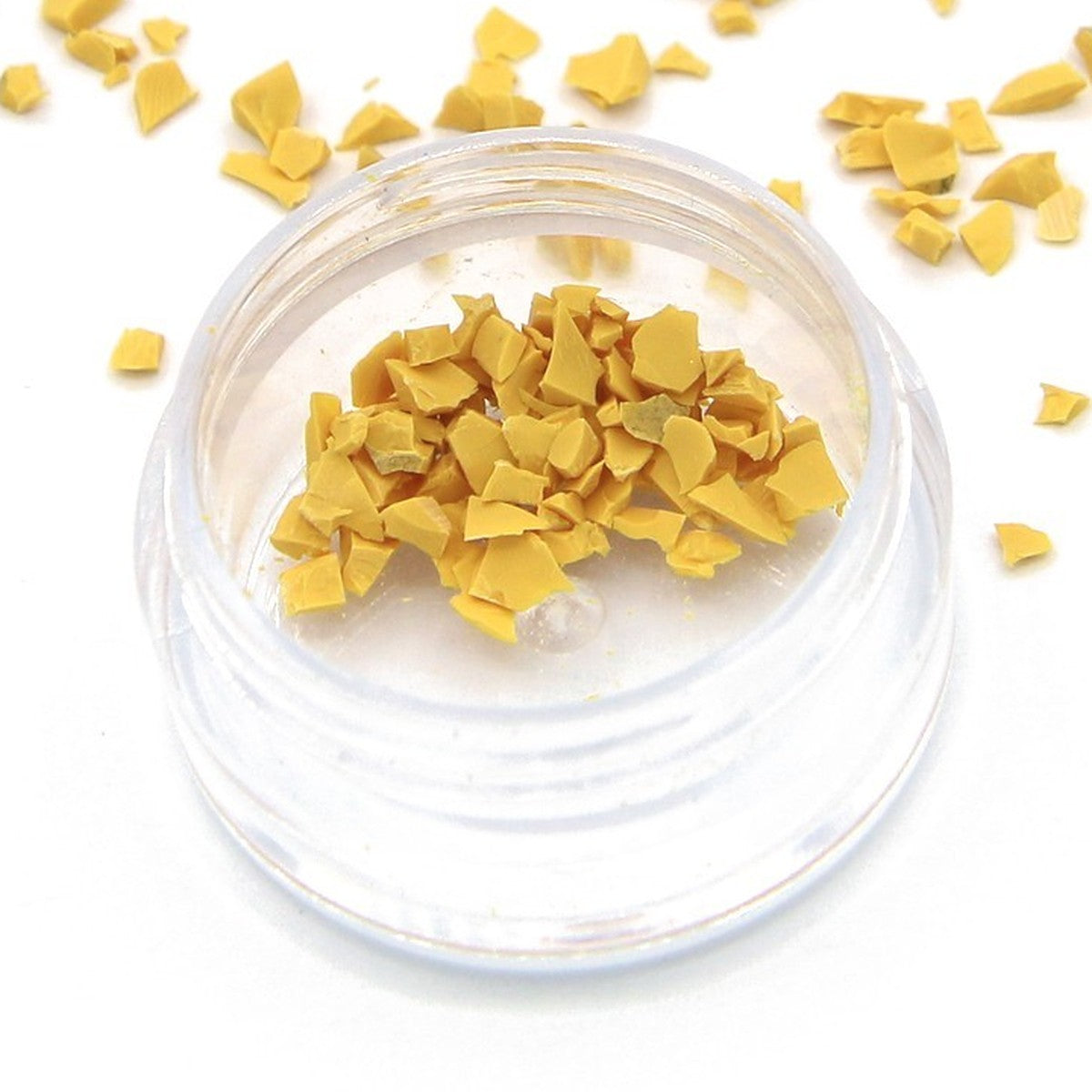 Close-up of yellow Colorstone fragments in a small jar
