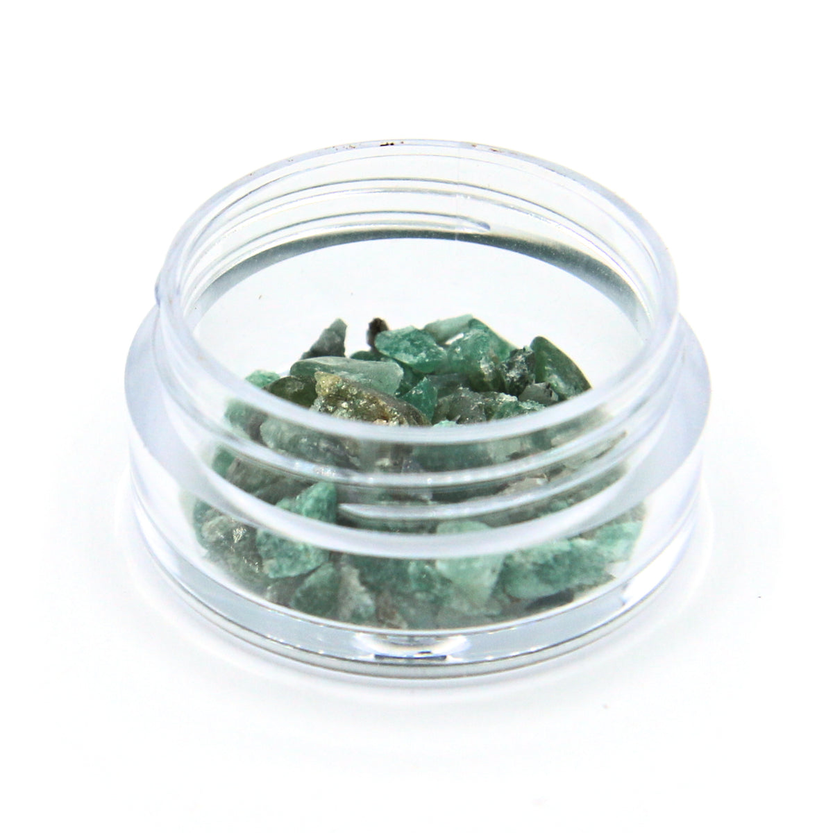 Emerald fragments in a 2 g jar, close up