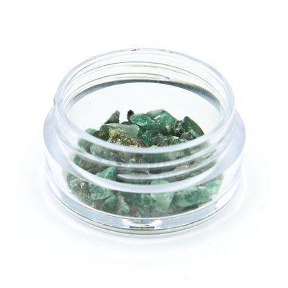 Emerald fragments in a 2 g jar, close up