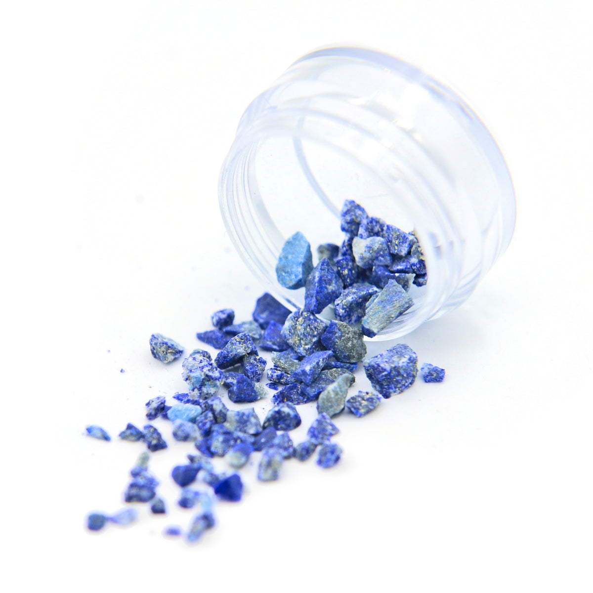 Lapis lazuli fragments spilling from a tipped 2 g jar