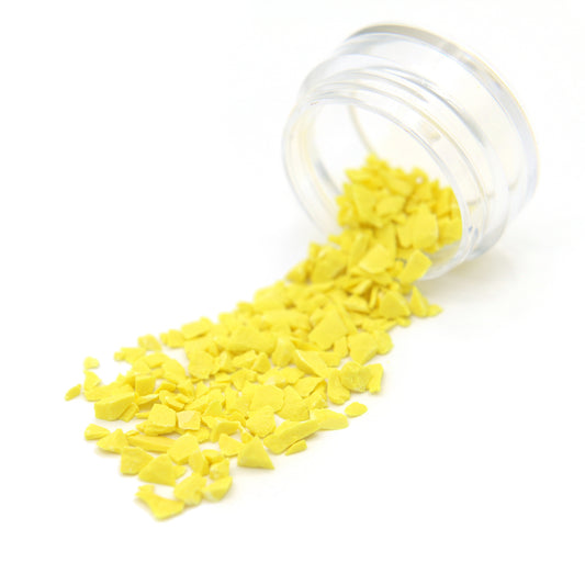 Light yellow Colorstone fragments spilling from a tipped 2 g jar