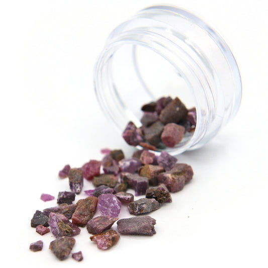 Ruby fragments spilling from a tipped 2 g jar