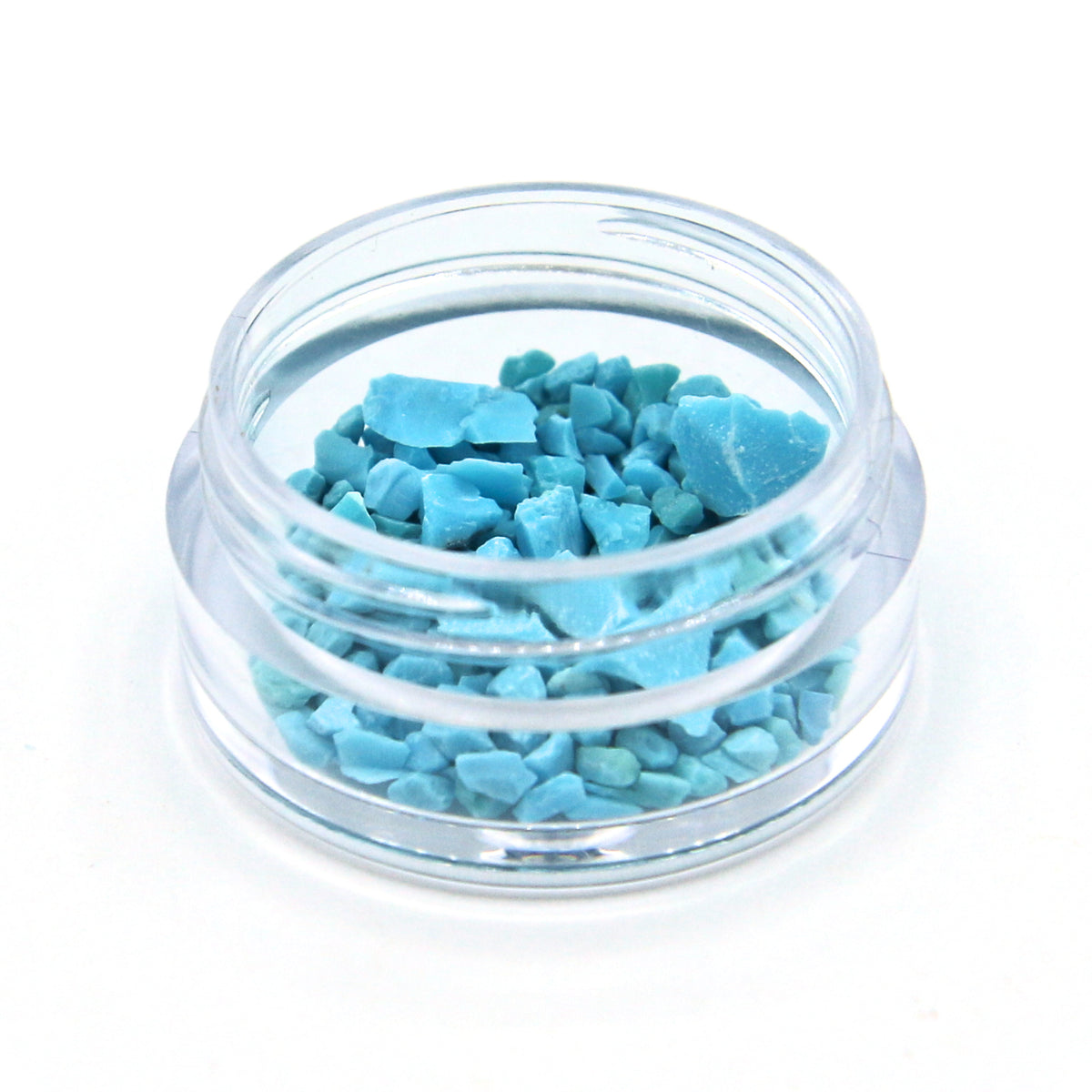 Turquoise fragments in a 2 g jar, close up