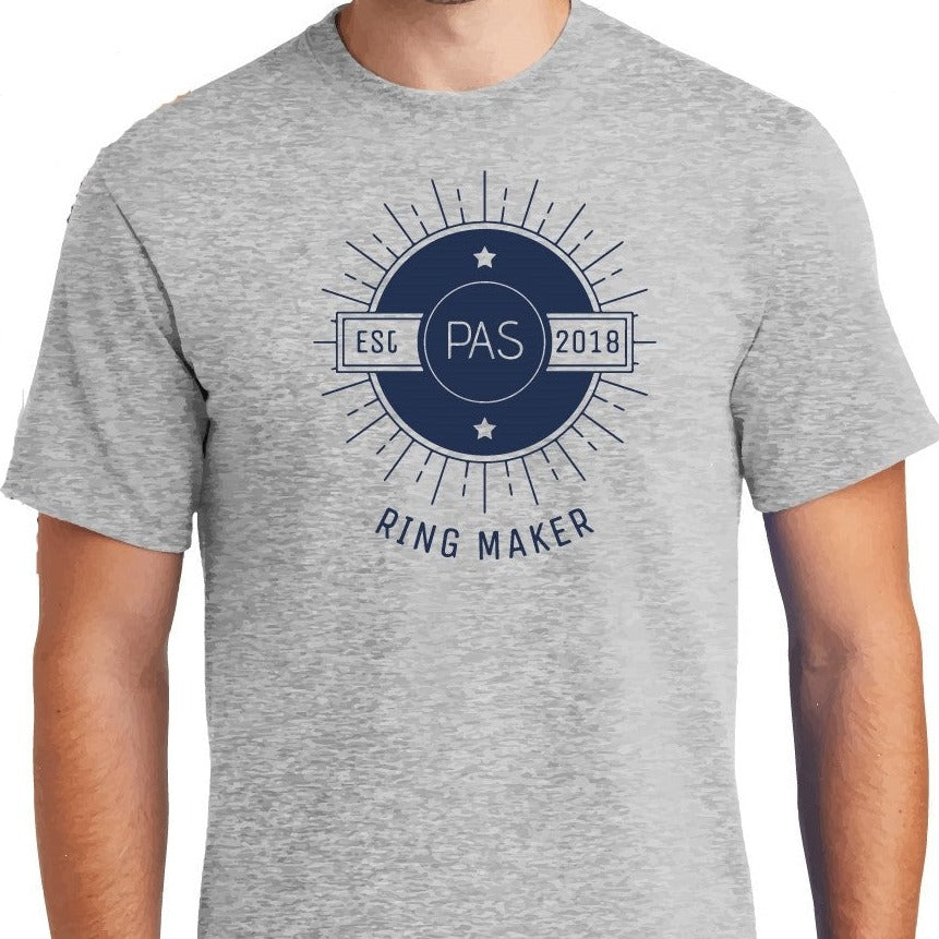 Light gray t-shirt with a navy blue sunburst design that reads, "PAS established 2018, Ring Maker"